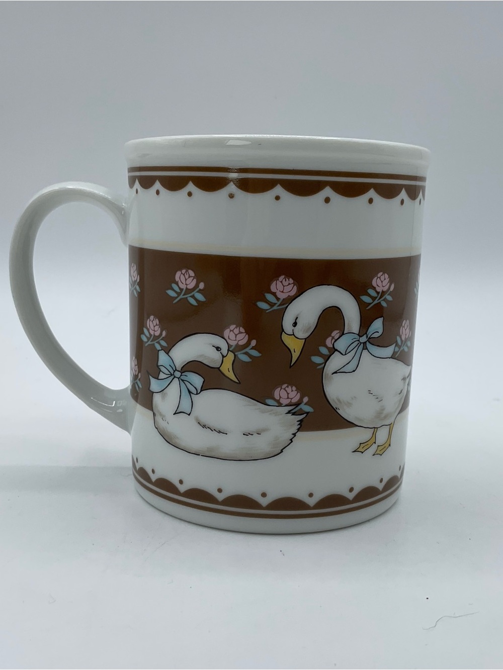 White Ceramic Goose Mug with Brown Accent and Pink Floral Motif duck mallard